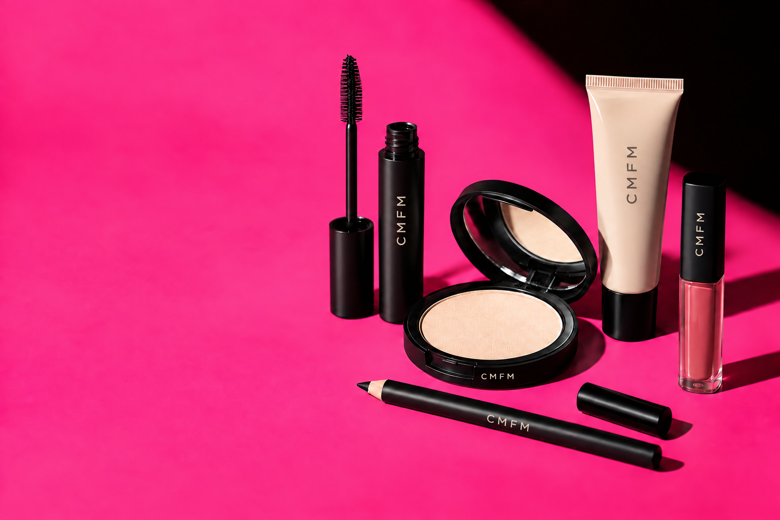 CMFM makeup essentials in simple black packaging on a hot-pink background